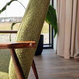 Mid-century modern armchair in olive green bouclé design by H. Lis.