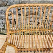 Fauteuil en rotin et piétement en métal noir 1960