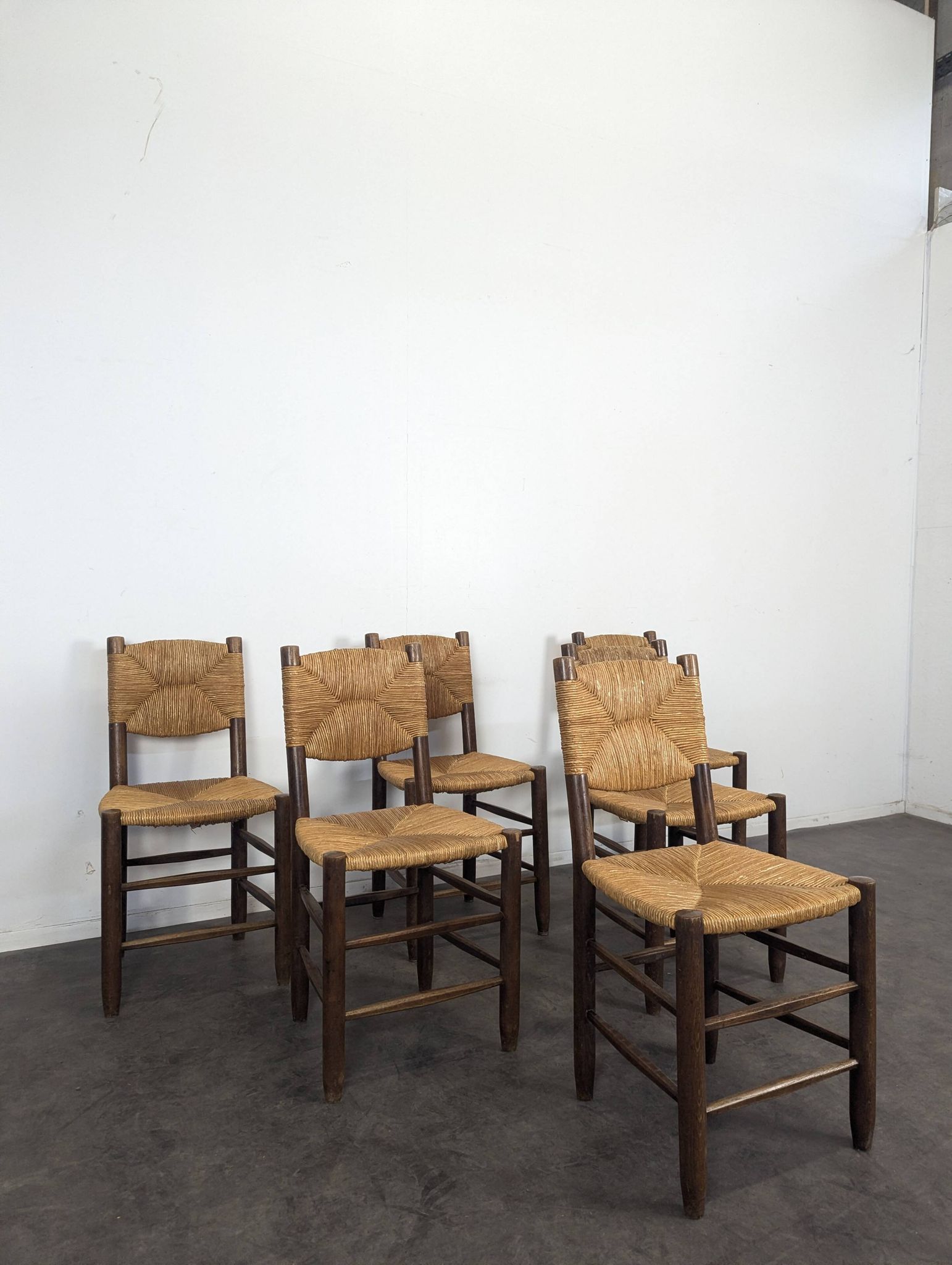 Set of 10 Bauche model chairs by Charlotte Perriand, circa 1960.