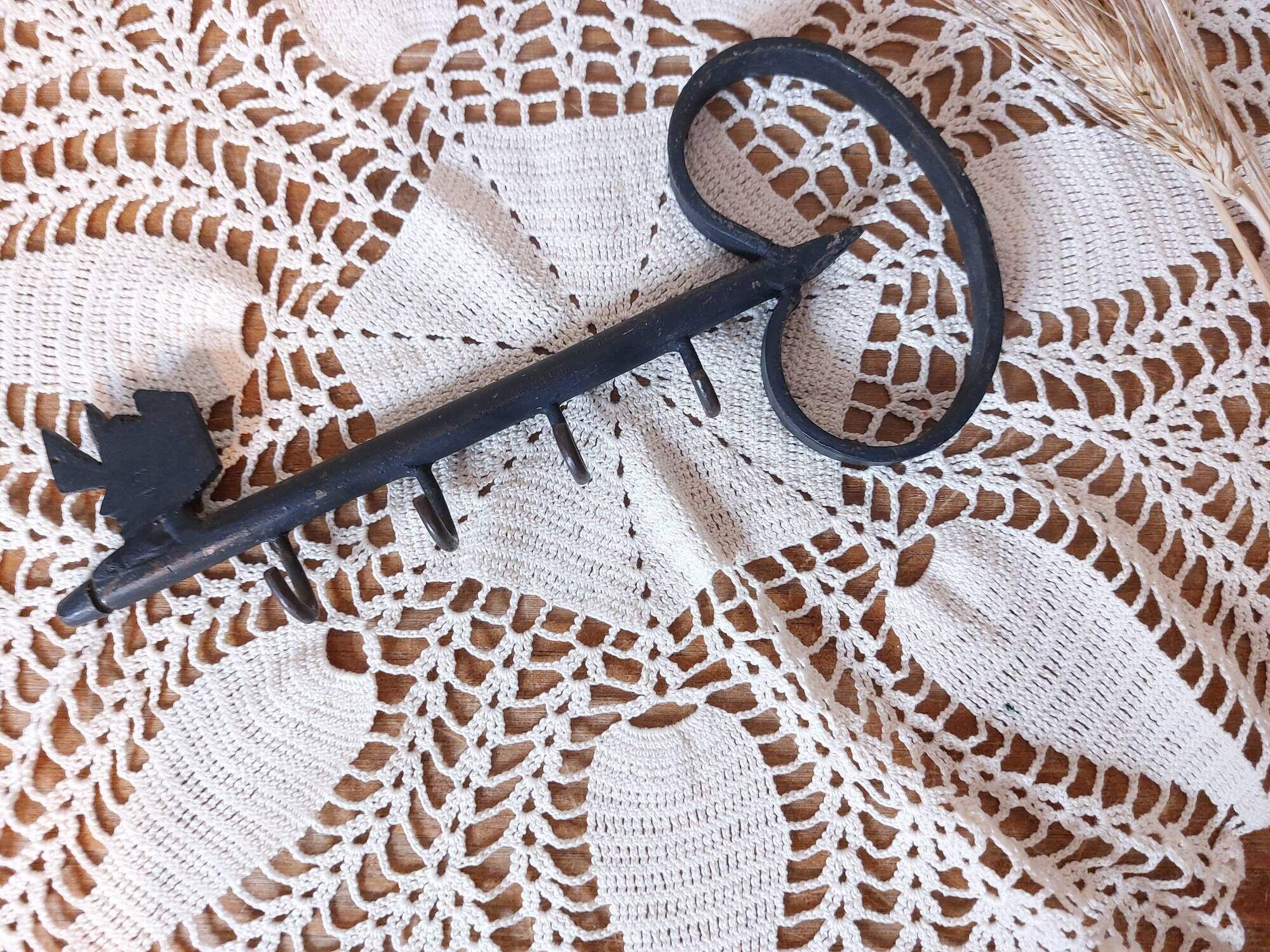 Old wall key holder in the shape of a vintage metal key 4 hooks