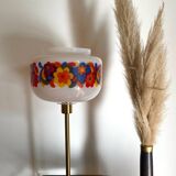 Table lamp with a vintage “flower power” glass globe and a gold base