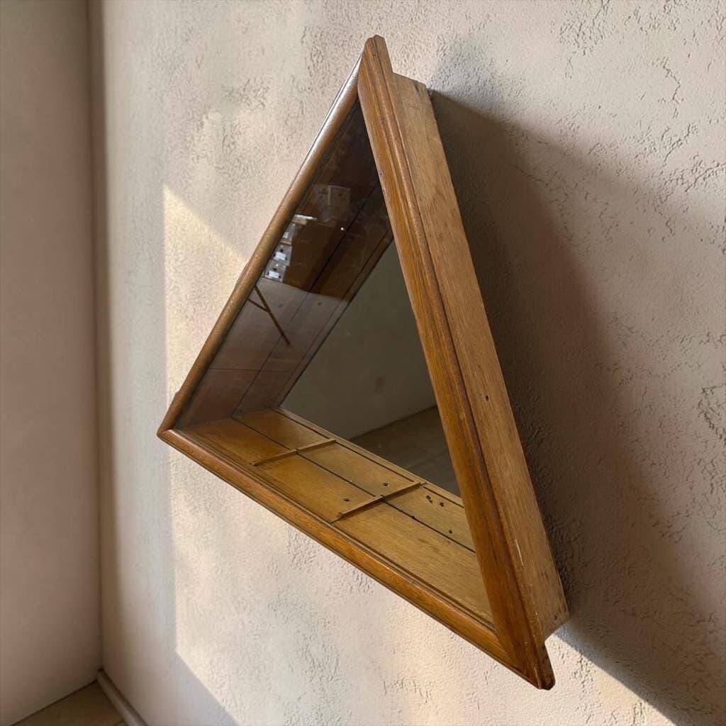 Vintage shallow wall display cabinet with a mirrored back.