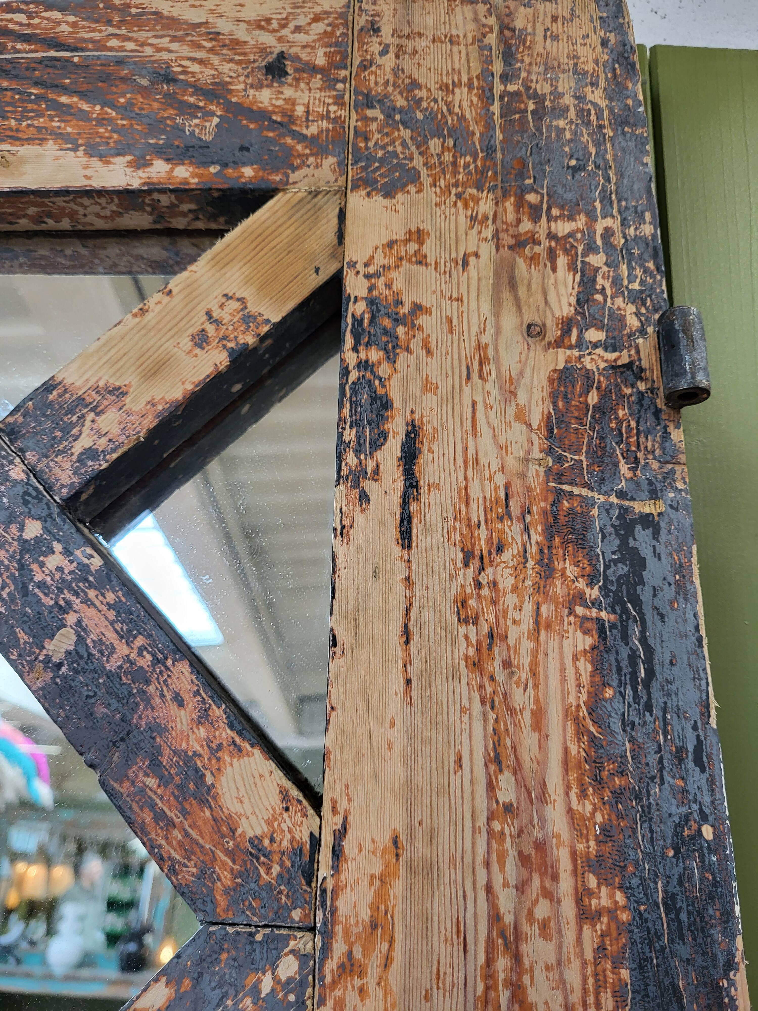Wooden mirror mounted on old door