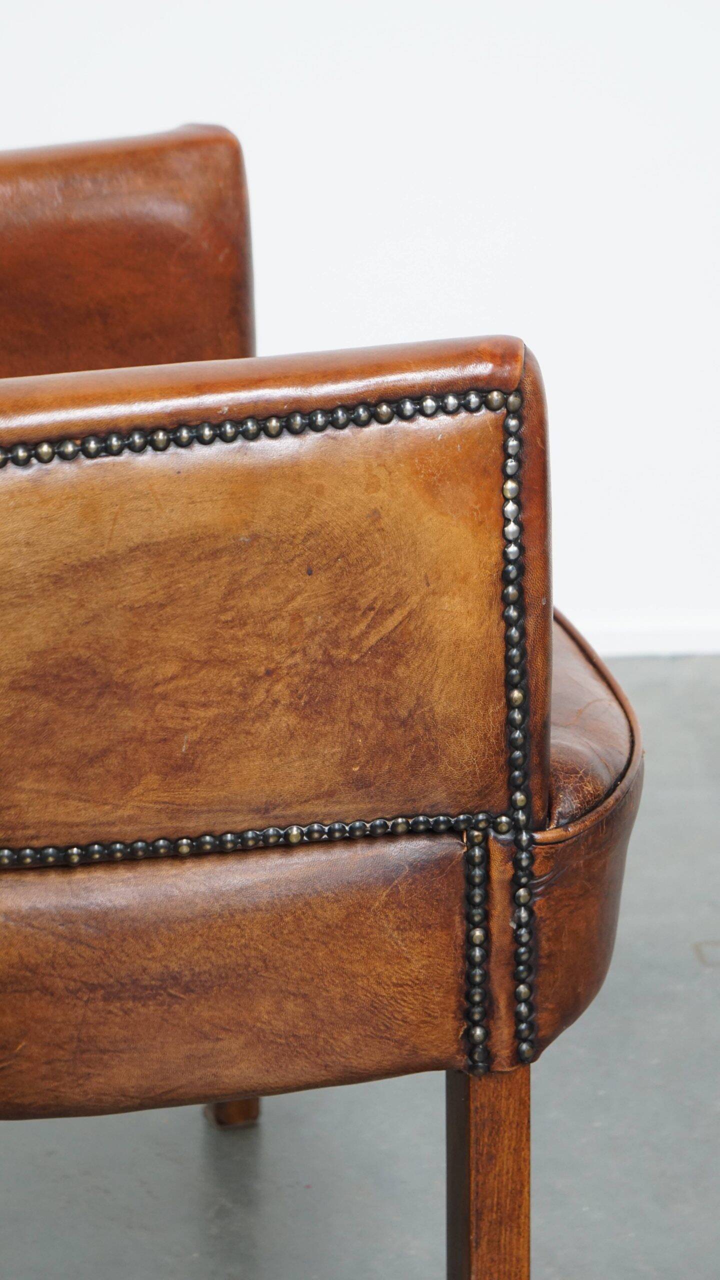 Amazing cognac-coloured sheepskin dining/side chair with armrests