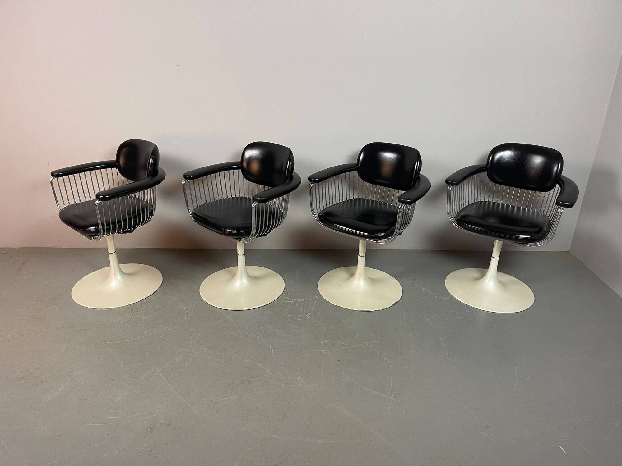 A striking set of four vintage swivel dining chairs