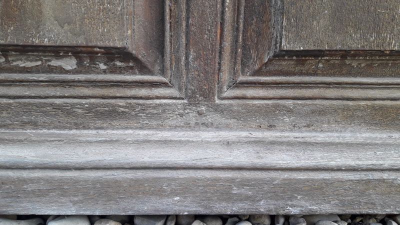 Oak entrance door and its frame and transom, wrought iron gates
