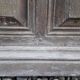 Oak entrance door and its frame and transom, wrought iron gates