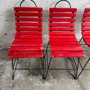 Red slatted chair with a black metal frame.