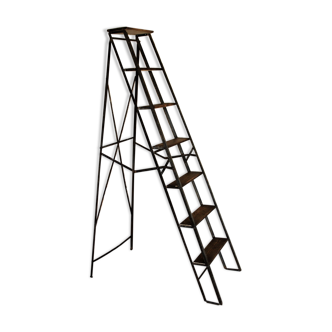 Old stepladder of folding workshop. Metal and wood.