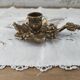Hand-held candle holder called "cellar rat" in brass with vine leaf decoration