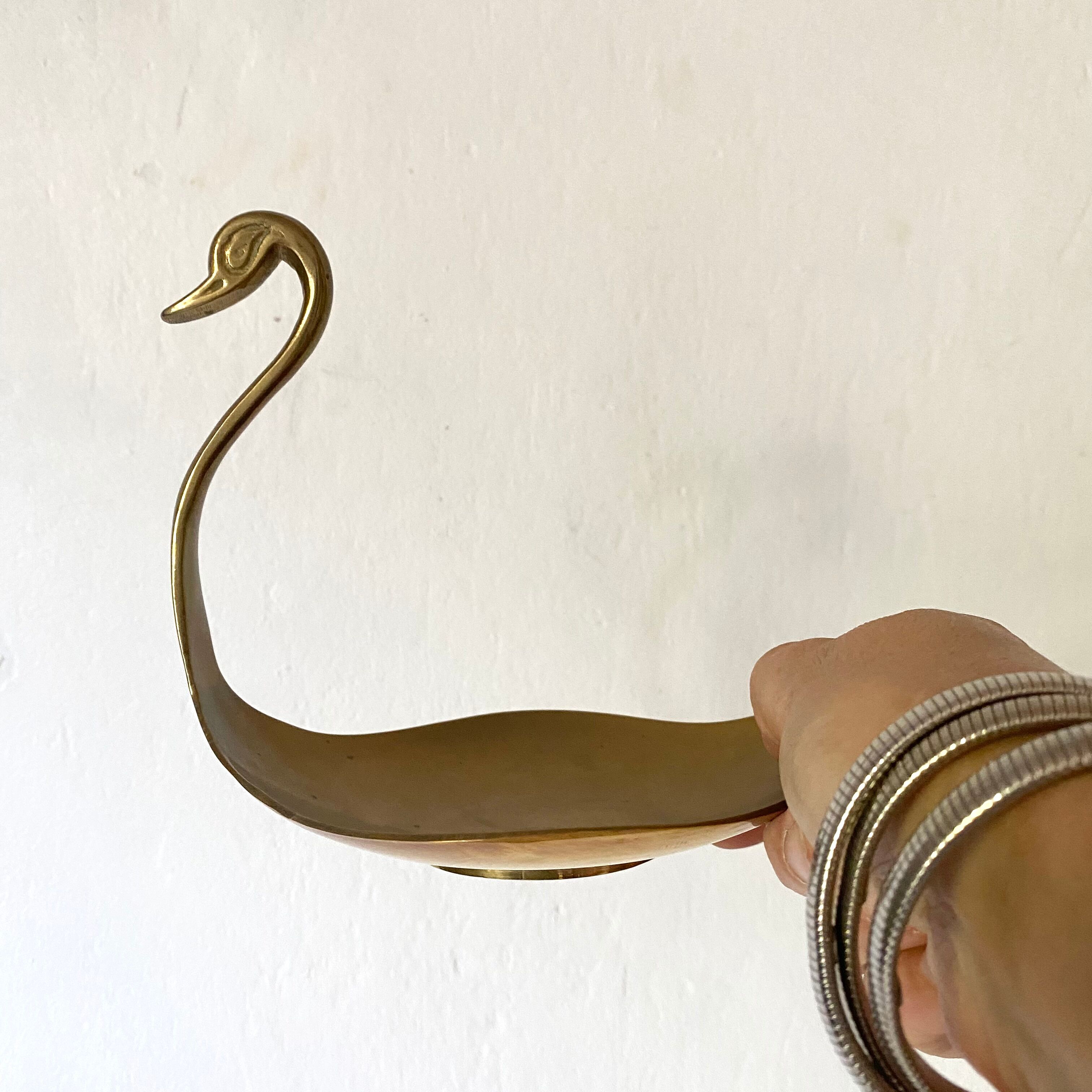 Empty brass swan pocket