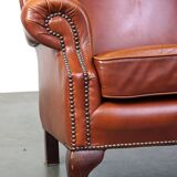 Elegant, smooth, and comfortable English Chesterfield wingback armchair in a beautiful classic color