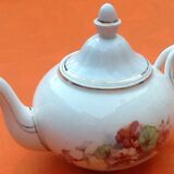 Old porcelain teapot with floral decoration