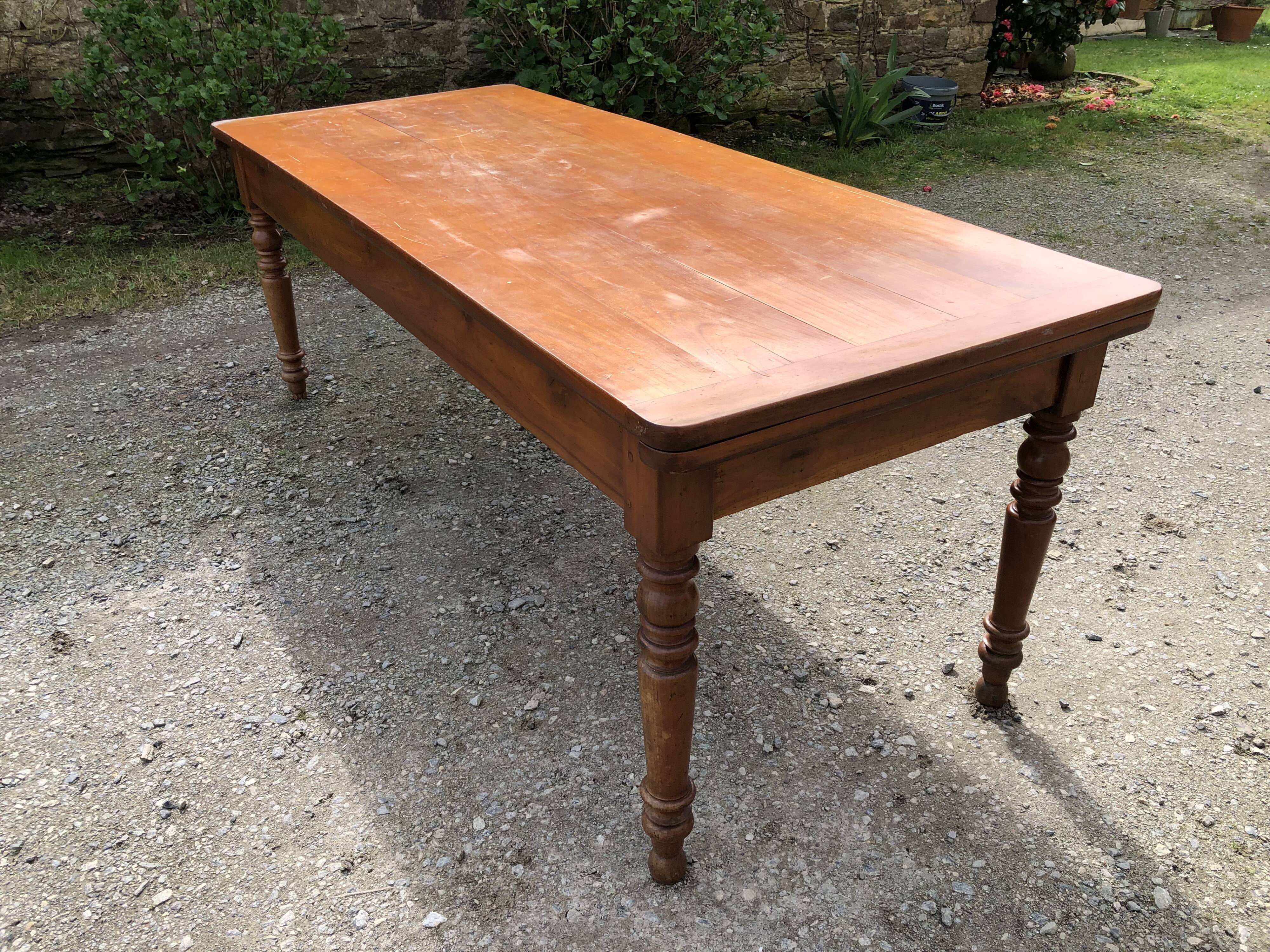 Antique Louis Philippe style farmhouse table in solid cherry wood with its 2 extensions.