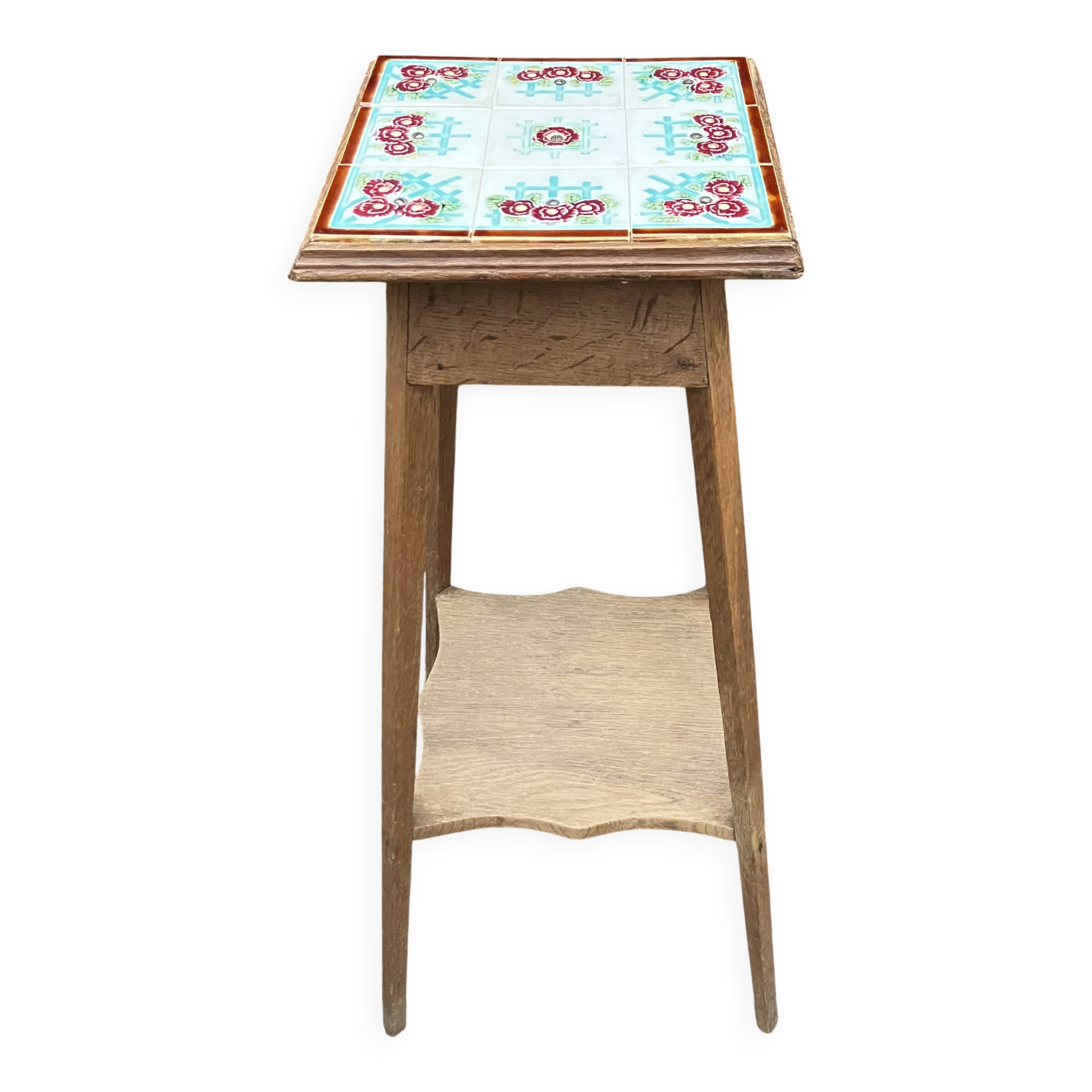 Antique wooden plant stand with ceramic tiles.