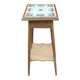 Antique wooden plant stand with ceramic tiles.