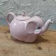 Antique pink elephant teapot in earthenware.