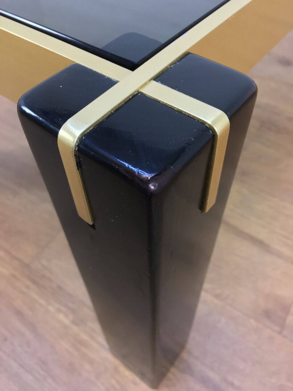 Italian coffee table from the 70s, smoked glass, black and gold lacquered wood.