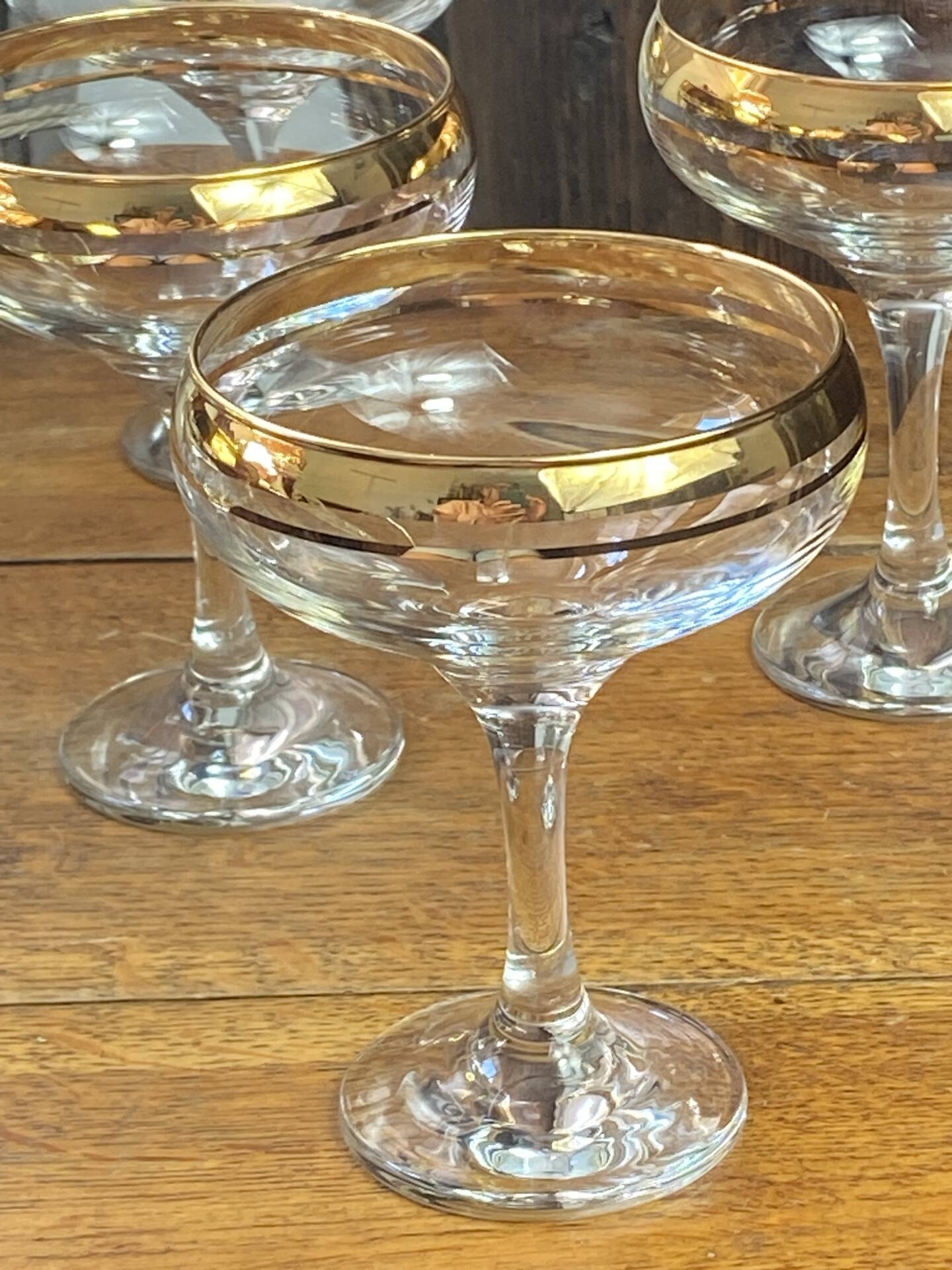 Champagne coupes or cocktail glasses with gilding