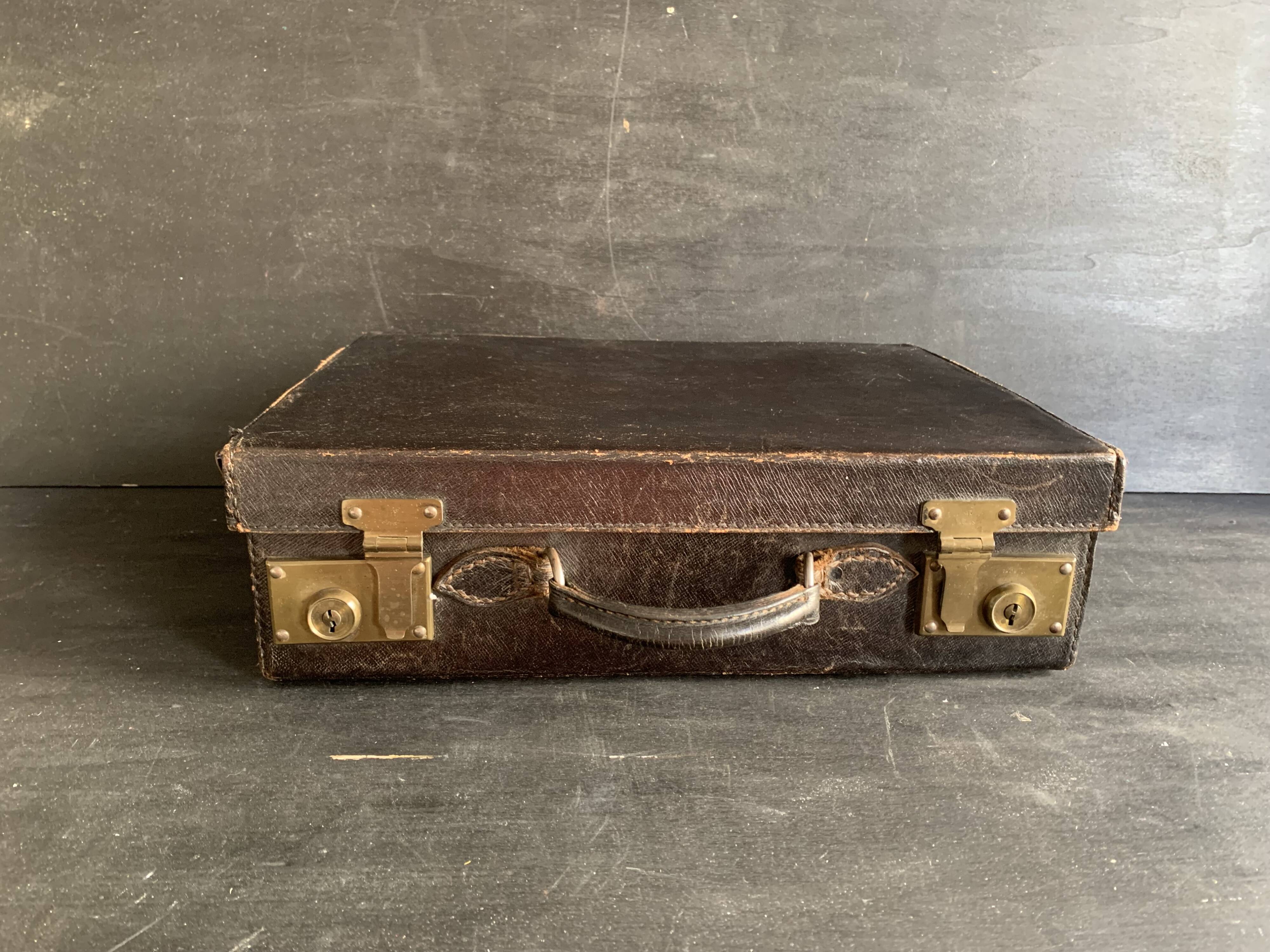 Small black grained leather travel suitcase from the 1920s