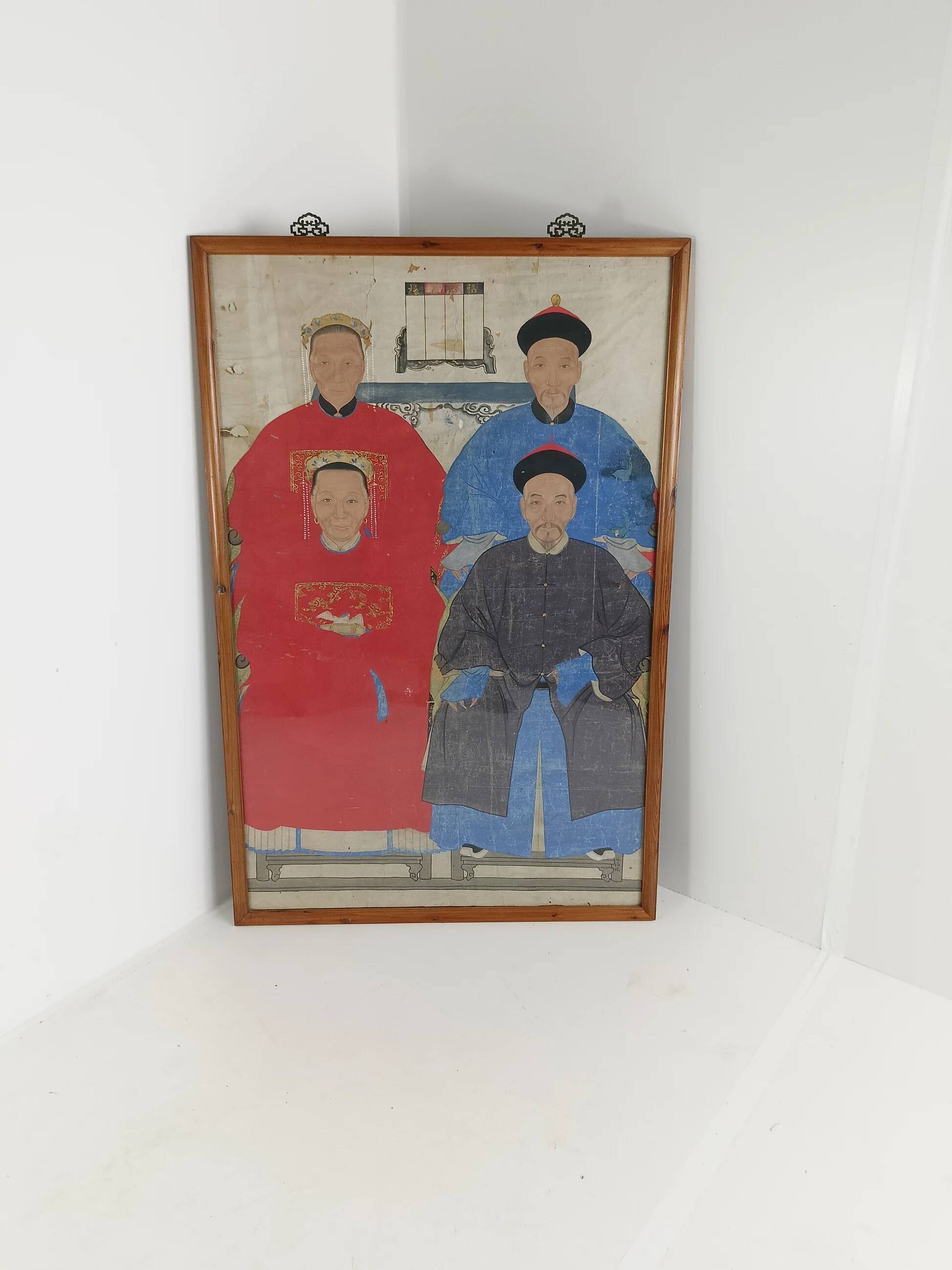 A framed Chinese ancestral portrait is a traditional hand-painted