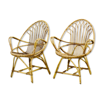 A pair of rattan chairs