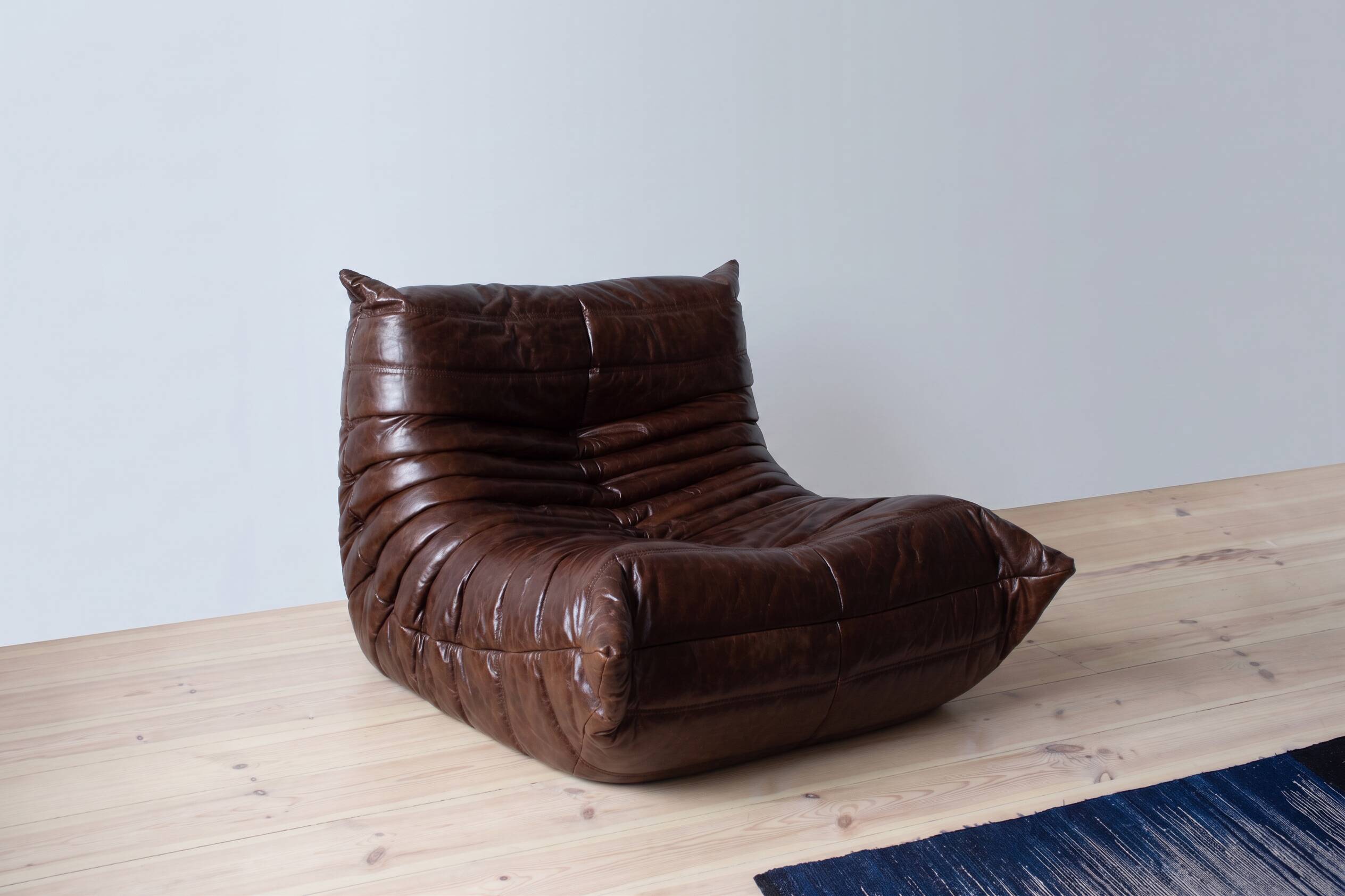 Togo armchair in dark brown shiny leather