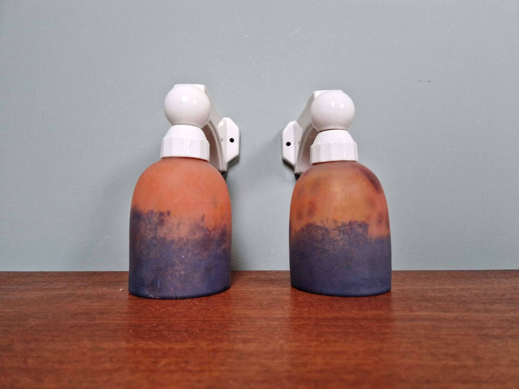 Pair of Art Deco wall sconces in multicoloured porcelain and frosted glass.