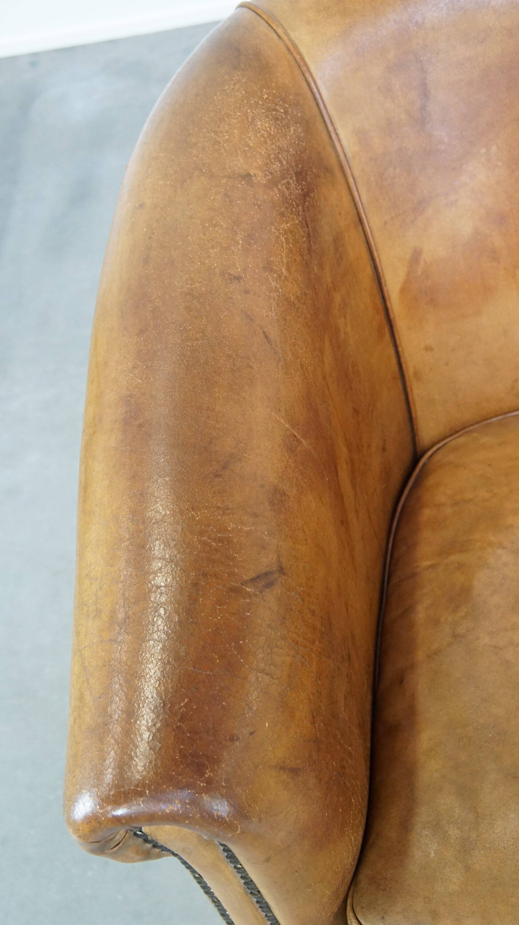 Comfortable, cozy, warm colored sheepskin club chair finished with decorative nails