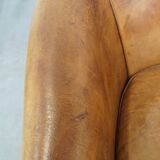 Comfortable, cozy, warm colored sheepskin club chair finished with decorative nails