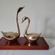 Duo of brass swans on base