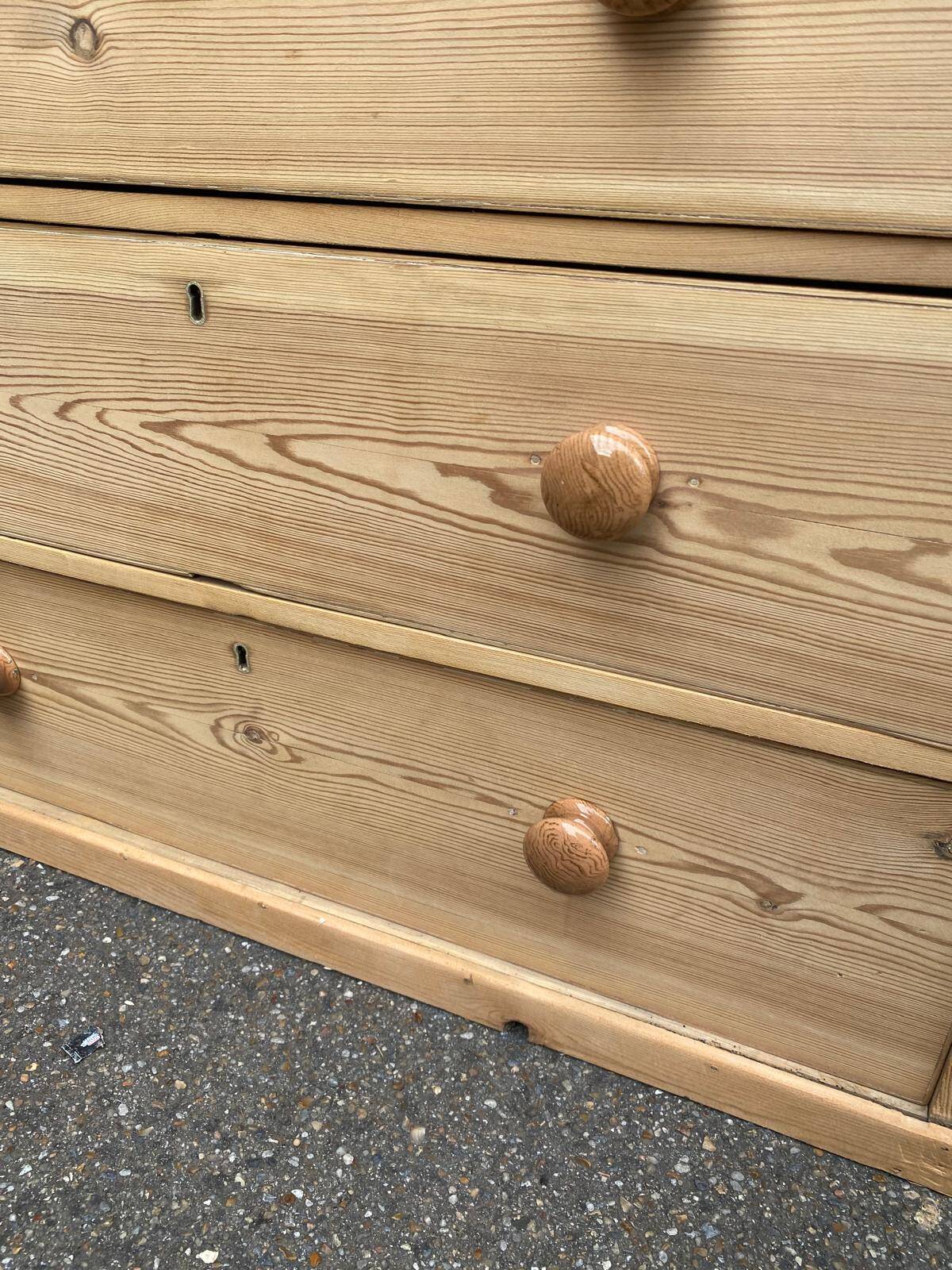 Victorian commode from the 19th century stripped to raw solid wood with ceramic knobs.