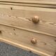 Victorian commode from the 19th century stripped to raw solid wood with ceramic knobs.