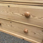 Victorian commode from the 19th century stripped to raw solid wood with ceramic knobs.
