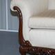Three-seater canapé carved from solid walnut with claw feet.
