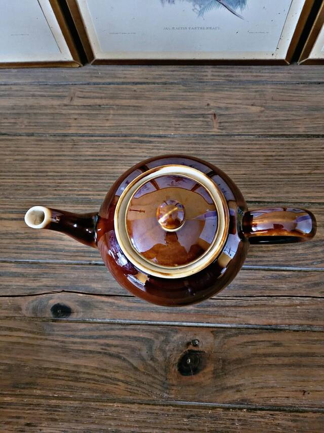 Vintage ceramic teapot (glazed earthenware) in brown colour.