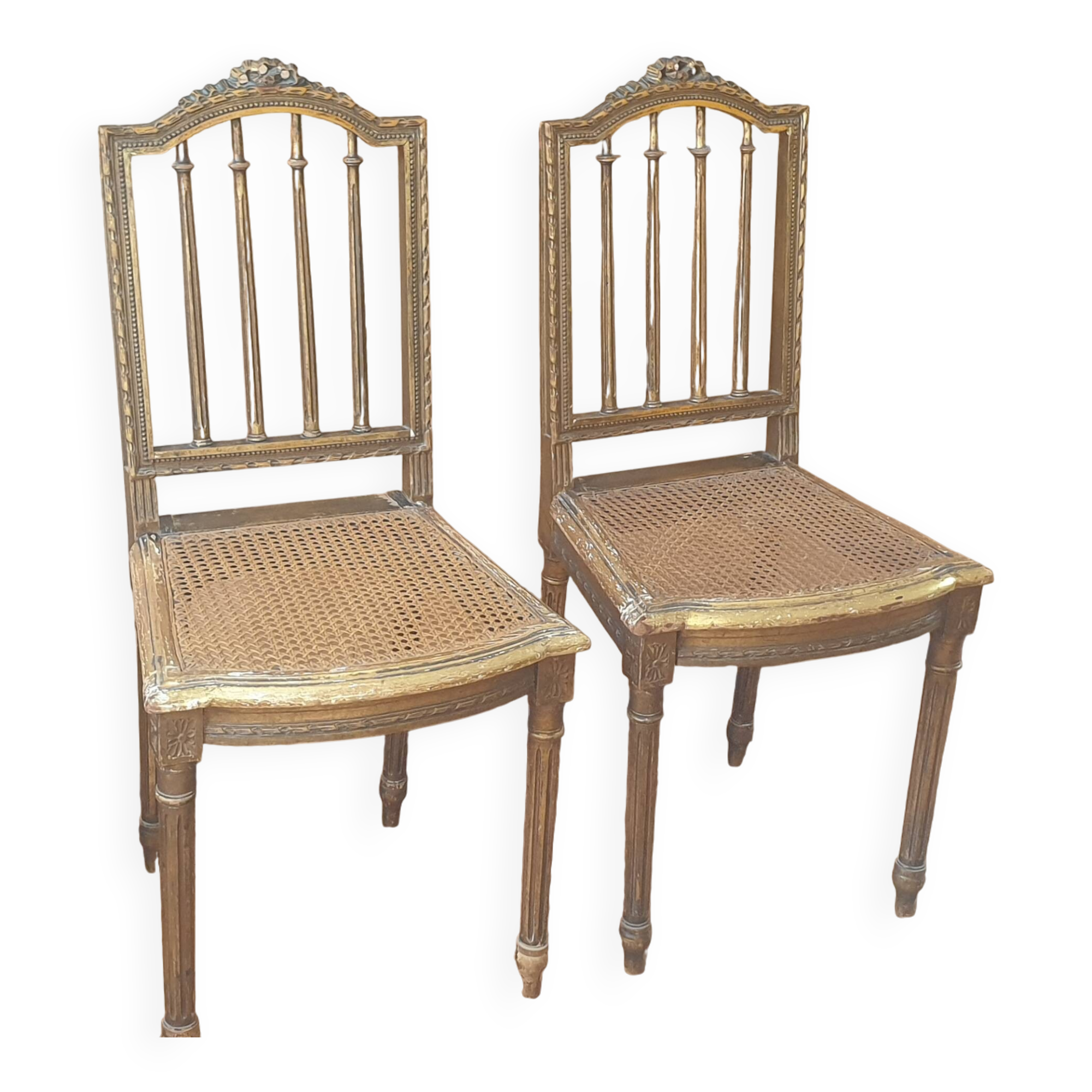 Pair of Louis XVI caned chairs with carved gilded wood.