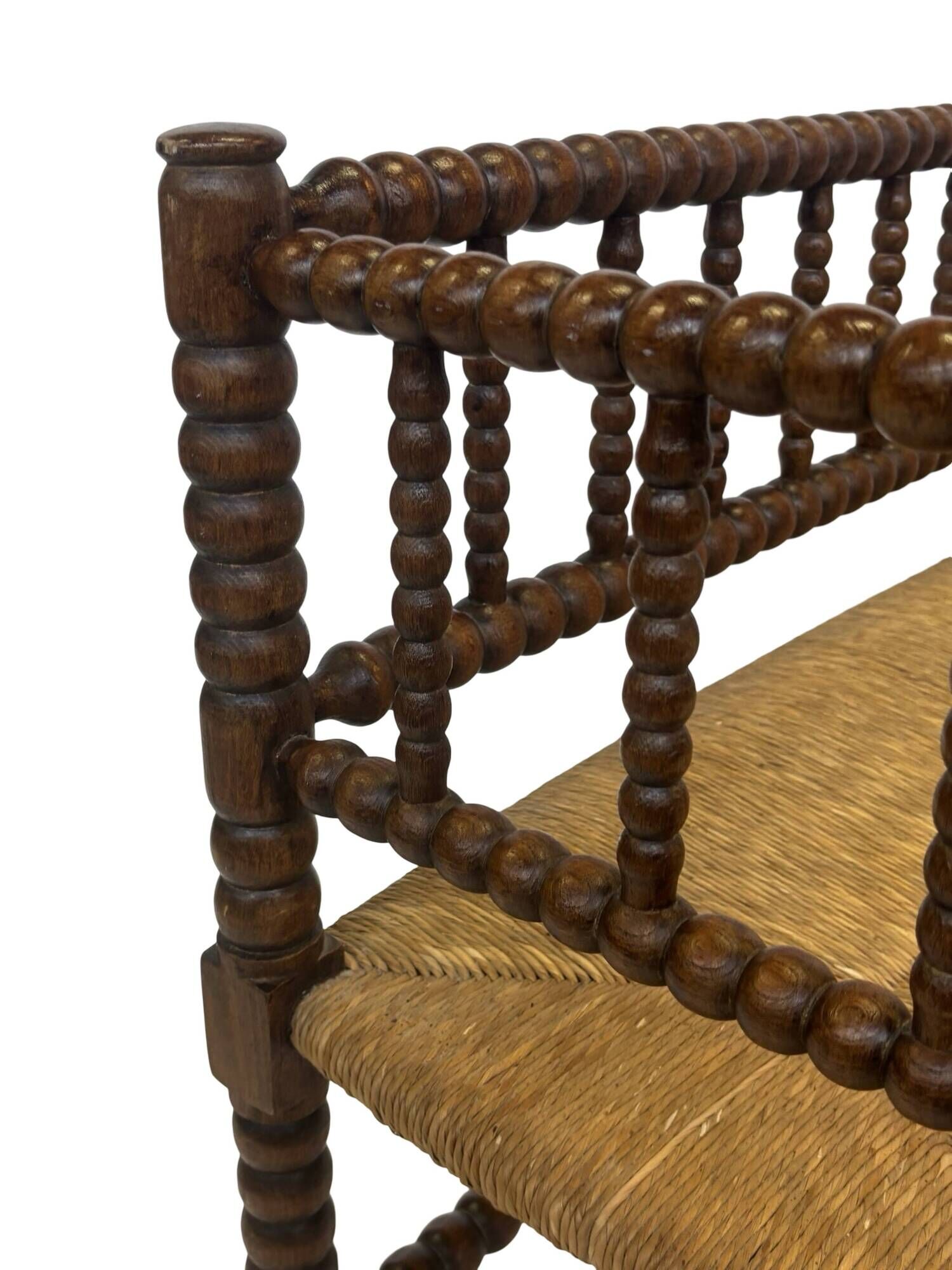 Vintage 'bobbin' bench with a rush seat, 1920s design with armrests.