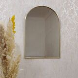 Brass wall mirror in the shape of a handmade holder
