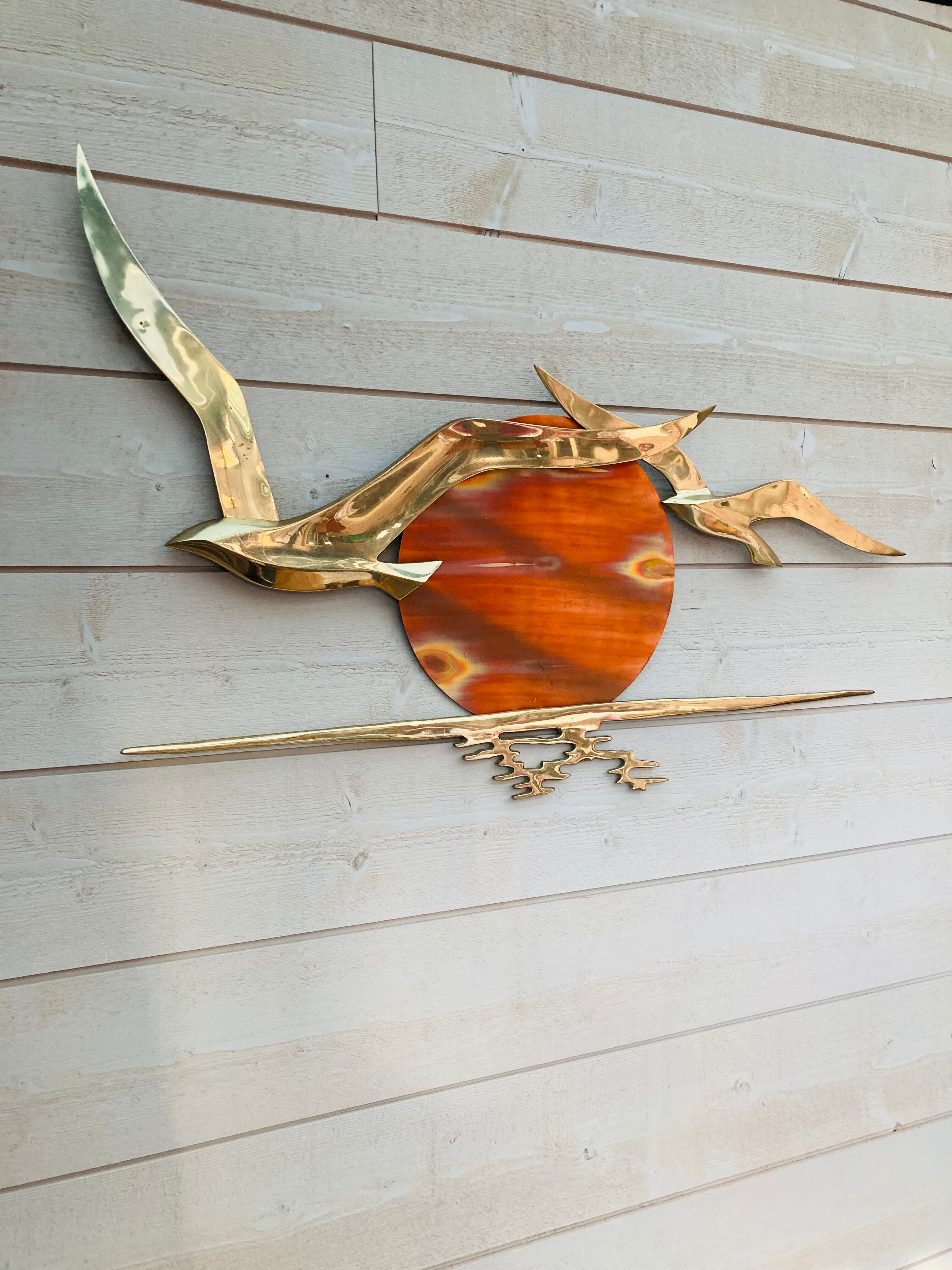 Bird brass and sun bronze wall decoration