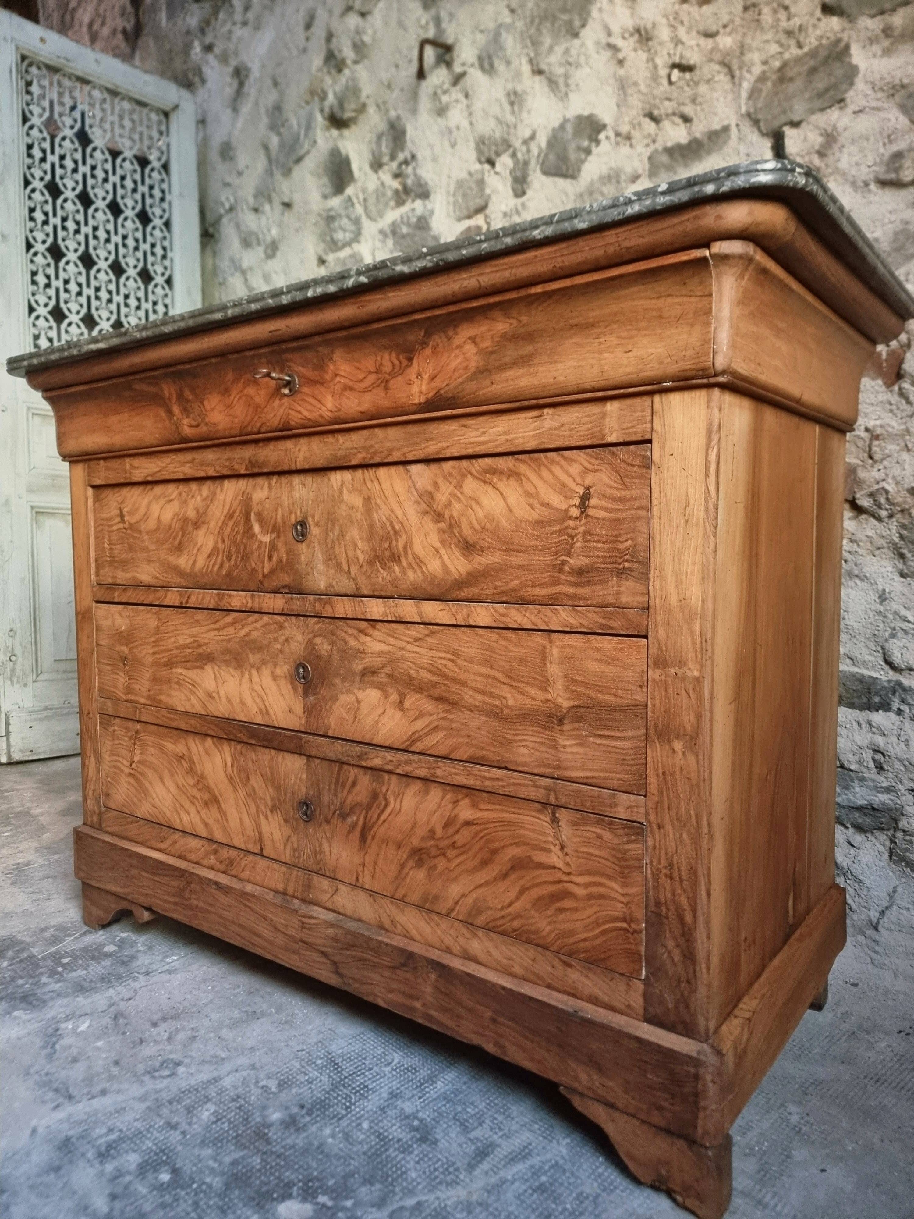 French antique walnut commode with a dark grey marble top, circa 1830–1860.