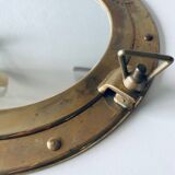 Porthole mirror in gilded brass