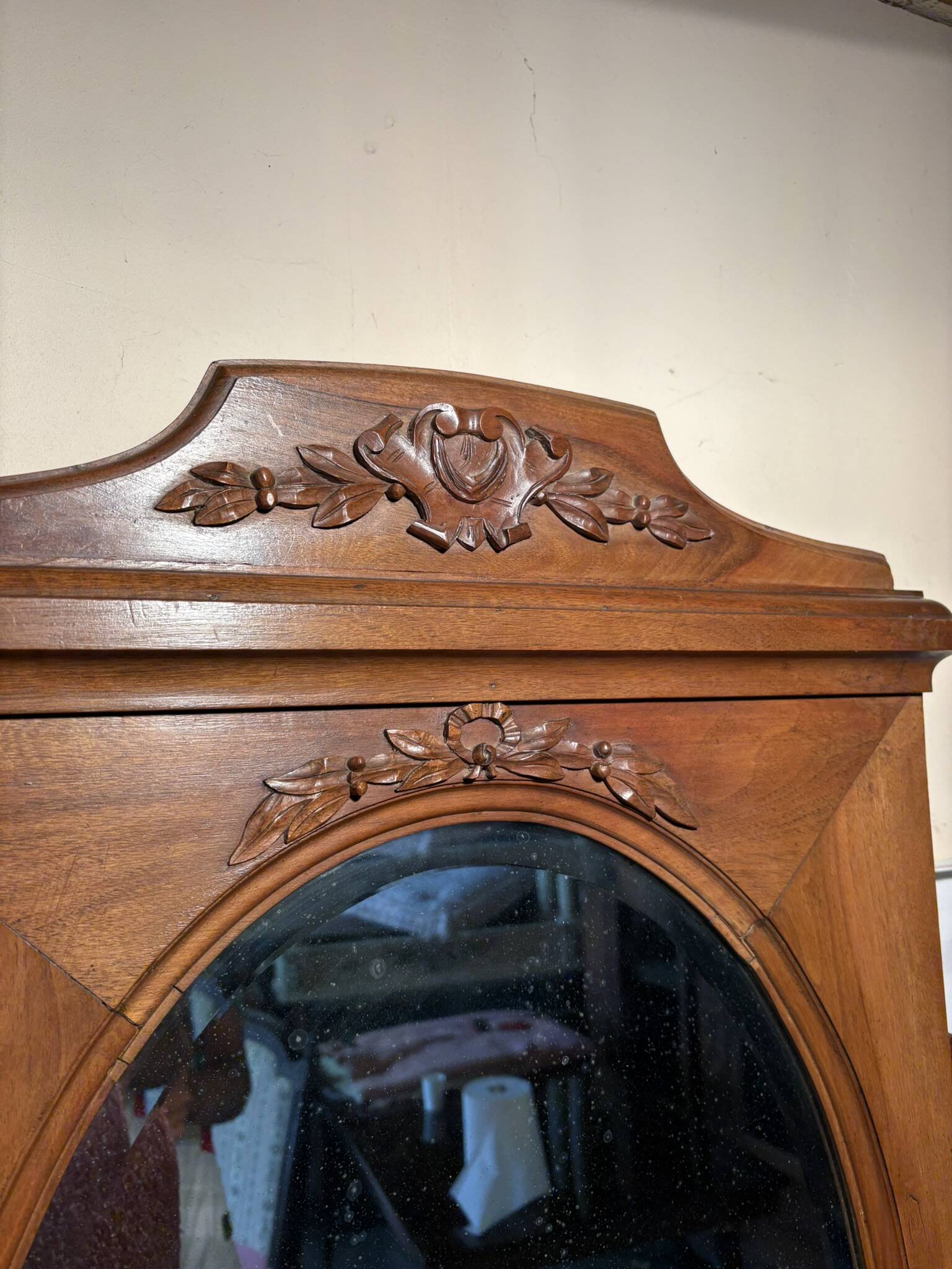 Antique carved wooden dressing table with marble and tilting oval mirror.