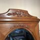 Antique carved wooden dressing table with marble and tilting oval mirror.