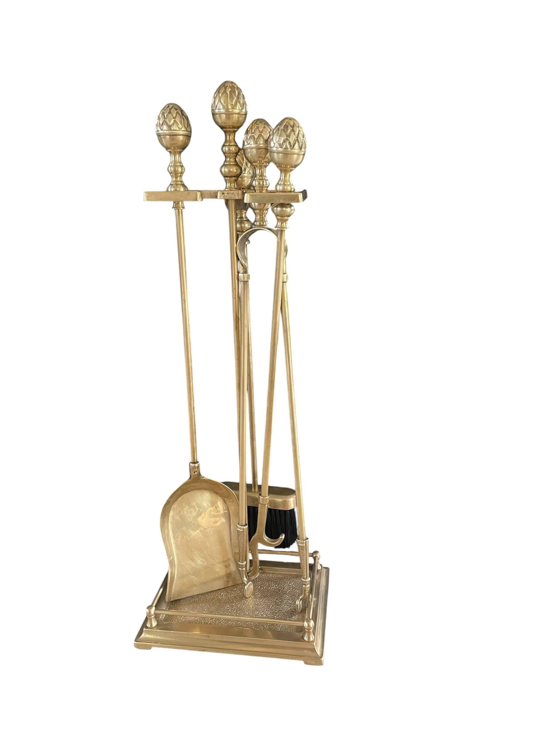 Brass fireplace tools in the style of Maison Baguès.
