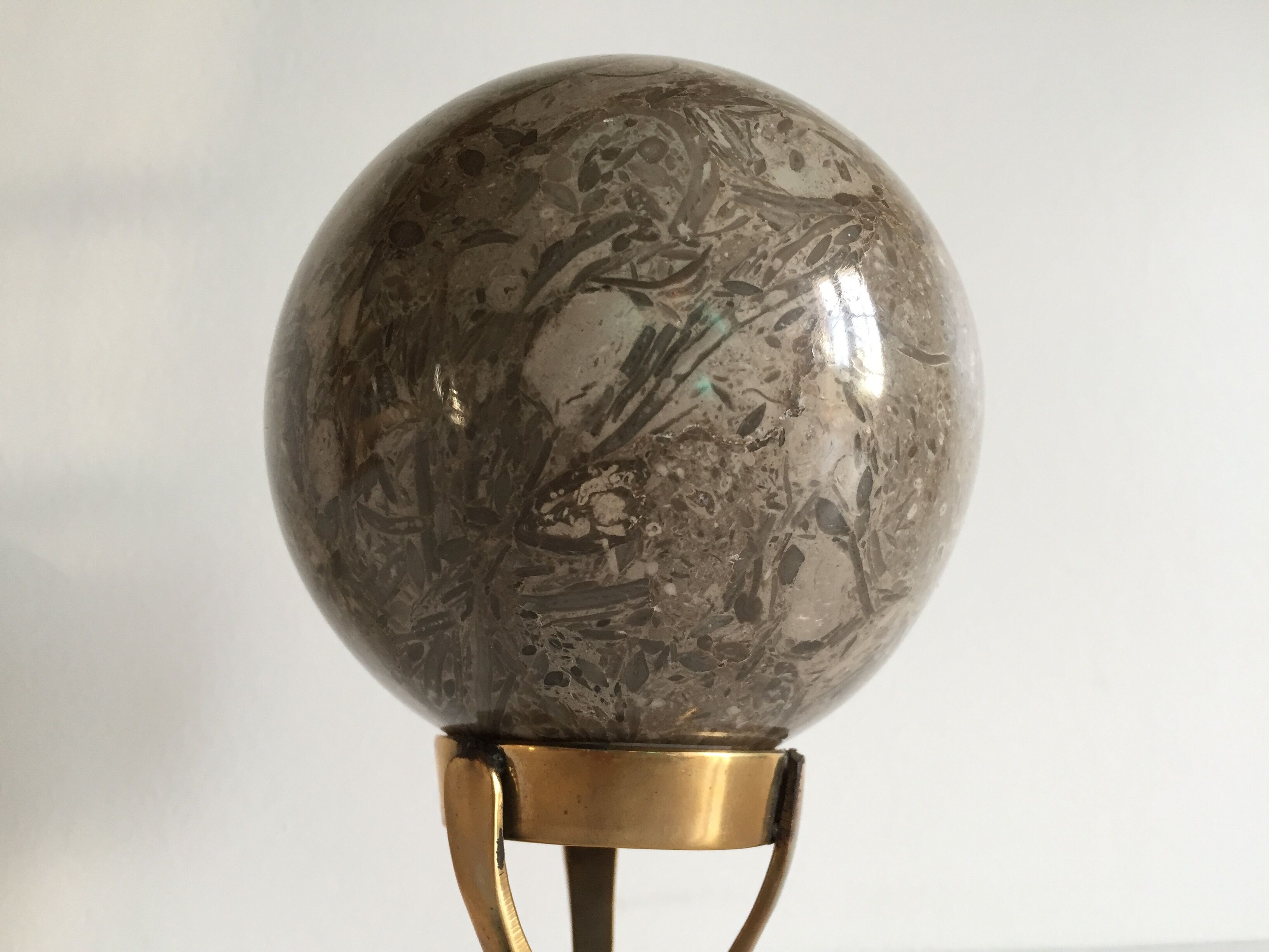 Marble ball paperweight on vintage brass