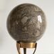 Marble ball paperweight on vintage brass