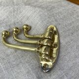 Coat hook with three-pronged folding hooks in brass