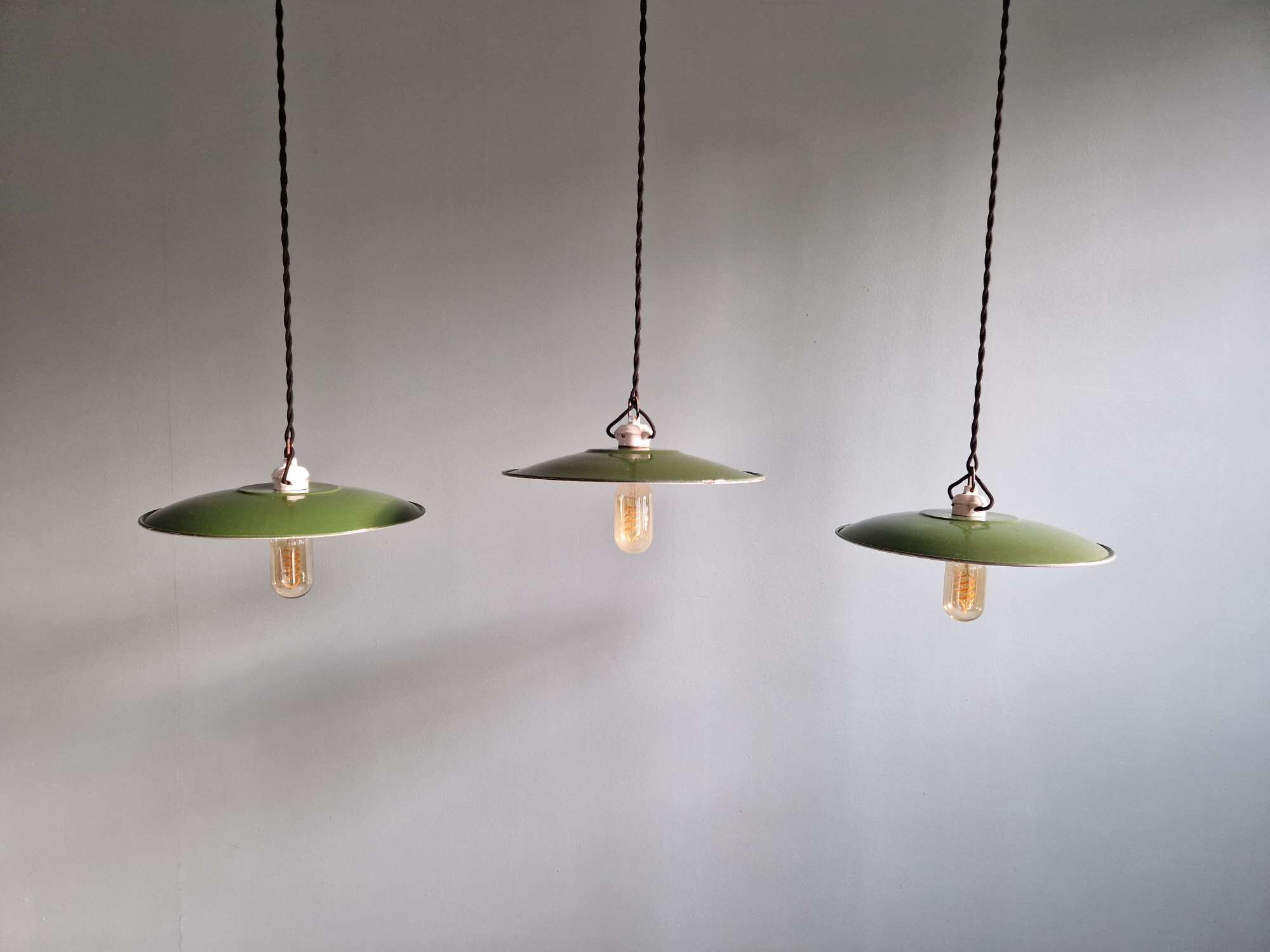 Trio of large industrial suspensions in green enamelled sheet metal.