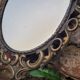 2 antique oval mirrors in heavy metal